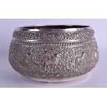 A LARGE 19TH CENTURY INDIAN SILVER EMBOSSED BUDDHISTIC BOWL decorated with birds, animals and