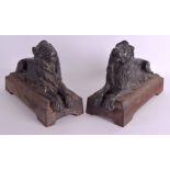 A PAIR OF 18TH/19TH CENTURY BRONZE AND CAST IRON DOOR STOPS formed as recumbent lions. 30 cm x 22