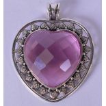 A SILVER MOUNTED FACETTED PINK GLASS PENDANT, heart shaped and stamped "925". 5.8 cm x 4.6 cm.