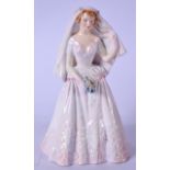 A ROYAL DOULTON PORCELAIN FIGURINE OF THE BRIDE, designed by Peggy Davies, formed as a young bride