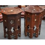 A PAIR OF ISLAMIC WOODEN STOOLS, inlaid with mother of pearl in foliate inspired decoration. 47 cm x