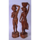 A LARGE PAIR OF CARVED WOODEN FIGURES, in the form of a female carrying a basket, together with a