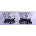 A GOOD PAIR OF MID 19TH CENTURY CHINESE FAMILLE ROSE PORCELAIN BOWLS with fitted hardwood stands,