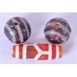 AN EARLY 20TH CENTURY CHINESE AGATE ZHU BEAD, together with a pair of agate beads. Largest 2.9 cm.