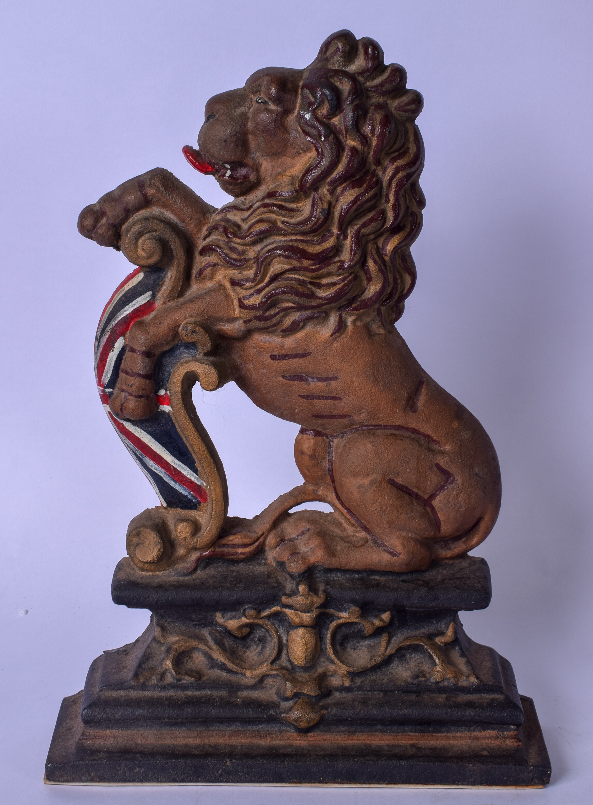 A CAST IRON DOORSTOP IN THE FORM OF A LION, modelled with its paws raised. 36 cm x 25 cm.