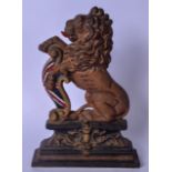 A CAST IRON DOORSTOP IN THE FORM OF A LION, modelled with its paws raised. 36 cm x 25 cm.