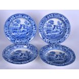 A SET OF FOUR SPODE BLUE AND WHITE SOUP PLATES, circa 1810, decorated with landscape scenery. 24.5