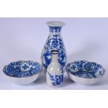 AN EARLY 20TH CENTURY JAPANESE BLUE AND WHITE PORCELAIN VASE, together with another and a pair of