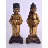 A RARE PAIR OF EARLY CHINESE GILT BRONZE FIGURES OF IMMORTALS Late Yuan/Ming, one modelled holding a