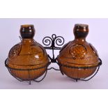 AN UNUSUAL VINTAGE AMBER GLASS FIRE GRENADE DISPLAY. Overall 24 cm wide.