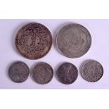 A GROUP OF SIX CHINESE COINS in various forms and sizes. (6)