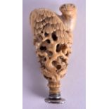 A MID 19TH CENTURY CHINESE CARVED IVORY SEAL in the form of a stylised ram upon a rocky outcrop. 7