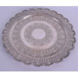 A LARGE 19TH CENTURY MIDDLE EASTERN SILVER SCALLOPED TRAY decorated in relief with flowers. 20 oz.