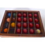 A COLLECTION OF VINTAGE SNOOKER BALLS, contained within a wooden case.