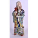 A 19TH CENTURY CHINESE FAMILLE ROSE PORCELAIN FIGURE OF AN IMMORTAL modelled holding a peach and