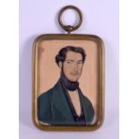 A REGENCY FRAMED PORTRAIT WATERCOLOUR MINIATURE depicting a male wearing a green coat. Image 10 cm x