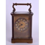 AN EARLY 20TH CENTURY FRENCH BRASS CARRIAGE CLOCK with Maltese style central dial. 14 cm high inc