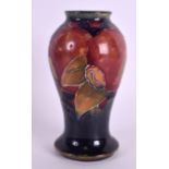 A SMALL WILLIAM MOORCROFT BALUSTER VASE decorated with pomegranate. 9.75 cm high.