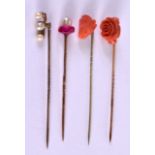 FOUR ANTIQUE STICK PINS including a carved coral lion head. (4)