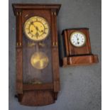 AN EARLY 20TH CENTURY WOODEN MANTEL CLOCK, together with a hanging wall clock. Largest 56 cm.