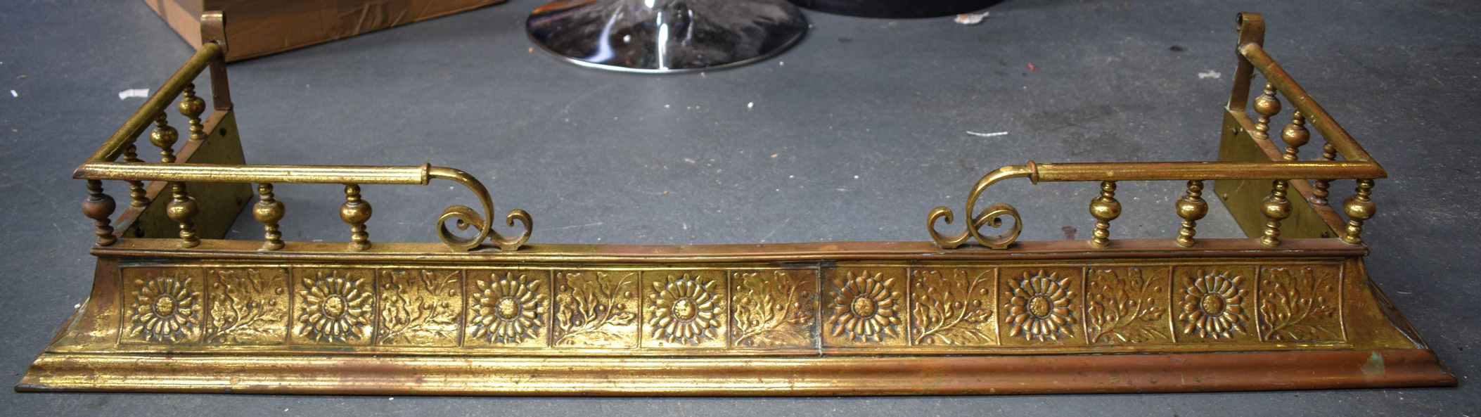 AN EARLY 20TH CENTURY ARTS AND CRAFTS COPPER AND BRASS FENDER, decorated with panels of flowers,