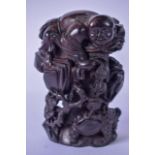A CHINESE CARVED HARDWOOD FIGURAL GROUP, carved in the form of a young boy on an outcrop teasing a