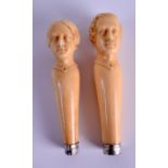 A RARE PAIR OF LARGE MID 19TH CENTURY EUROPEAN IVORY CANE HANDLES of possibly desk seals, formed
