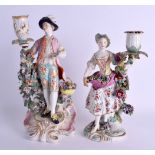A PAIR OF 18TH CENTURY DERBY CANDLESTICKS in the form of a boy and girl, probably painted by the