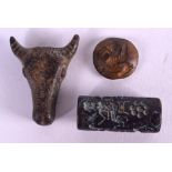 A ROMAN BRONZE COW HEAD together with two Middle Eastern stamp seals. (3)