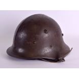 A MILITARY HELMET with leather strap. 26 cm x 16 cm.