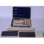 AN EARLY 20TH CENTURY PART TECHNICAL DRAWING SET, together with a slide rule. (2)
