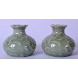 A PAIR OF EARLY 20TH CENTURY CELADON PORCELAIN VASES, decorated with foliage and formed with lobed