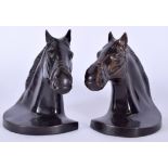 A PAIR OF HORSE HEAD BOOKENDS, by Buchstutz. 17 cm wide.