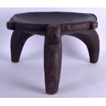 AN EARLY 20TH CENTURY AFRICAN TRIBAL CARVED WOOD STOOL possibly Tanzanian, with dish shaped top.