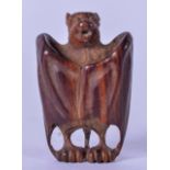 AN EARLY 20TH CENTURY JAPANESE WOODEN NETSUKE IN THE FORM OF A BAT, carved standing with wings