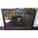 A VINTAGE PUB ADVERTISING MIRROR, depicting Guinness Extra Stout. 44 cm x 62 cm.