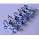 A SET OF SIX ORIENTAL STYLE PORCELAIN KNIFE REST, in the form of mythical creatures. 6.6 cm.