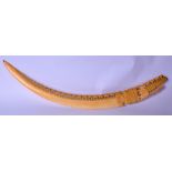 A LARGE LATE 19TH CENTURY AFRICAN TUSK, carved with extensive elephants. 79 cm wide.