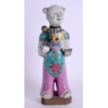 AN 18TH/19TH CENTURY CHINESE FAMILLE ROSE FIGURE OF A BOY modelled holding a lingzhi fungus, painted