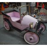 A VINTAGE CHILD'S RIDE ON PINK PEDAL CAR, "Lady Penelope". 96 cm long.