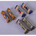 THREE SETS OF CONTINENTAL POTTERY KNIFE RESTS, decorated with foliage. (6)