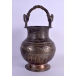AN 18TH/19TH CENTURY MIDDLE EASTERN SILVER INLAID SWING HANDLED VASE decorated with various