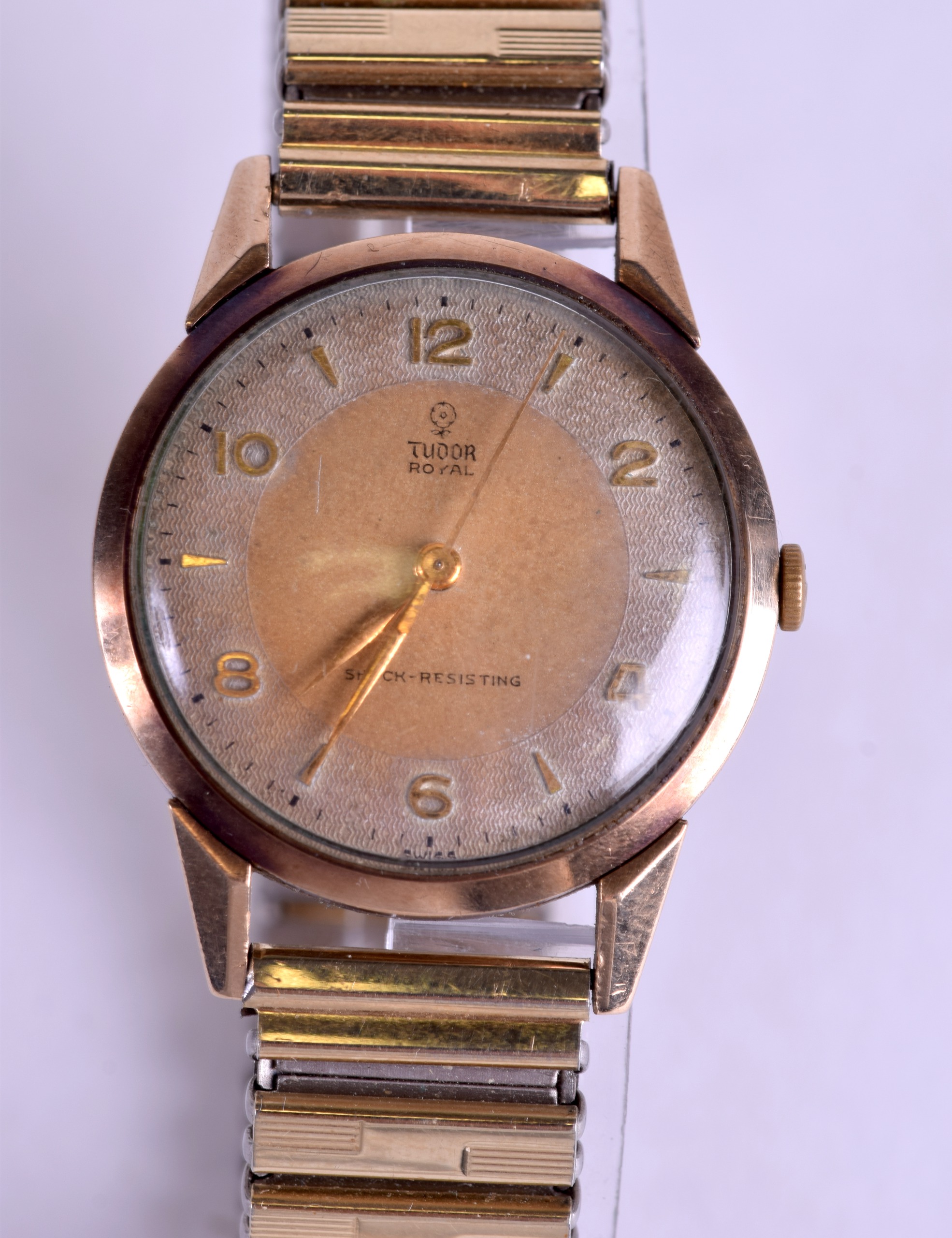 A 9CT GOLD TUDOR ROYAL SHOCK RESISTANT WRISTWATCH with flexible strap. Dial 3 cm diameter.