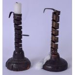 A MATCHED PAIR OF 19TH CENTURY PIG'S TAIL CANDLESTICKS, formed on wooden bases. 19 cm high.