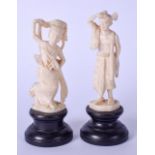 A PAIR OF EARLY 20TH CENTURY CARVED EASTERN IVORY FIGURES, in the form of a male and female. Largest