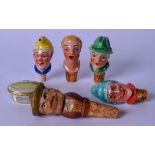 A GROUP OF FOUR VINTAGE PORCELAIN BOTTLE STOPPERS, together with a wooden stopper with moveable