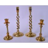 A LARGE PAIR OF EARLY 20TH CENTURY BRASS TWIST CANDLESTICKS, together with a smaller pair with
