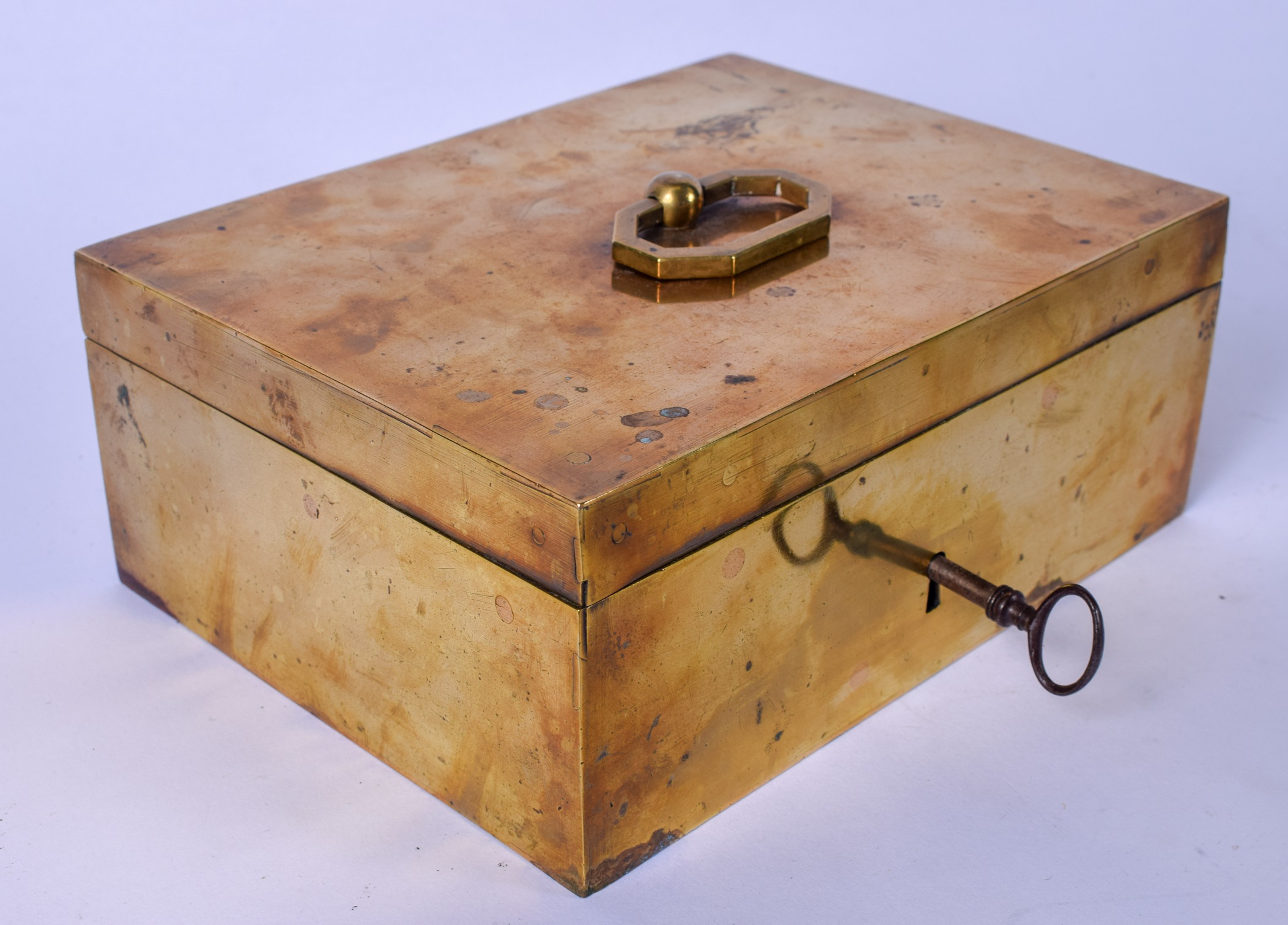 A HEAVY BRASS BOX WITH OCTAGONAL HANDLE, complete with original key. 20 cm wide.