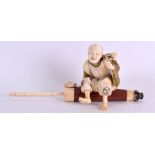 A LOVELY 19TH CENTURY JAPANESE MEIJI PERIOD CARVED AND STAINED IVORY OKIMONO modelled as a seated