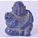 A 20TH CWNTURY CHINESE CARVED STATUE OR BUDDHA, carved holding a fish with a jovial expression. 4.